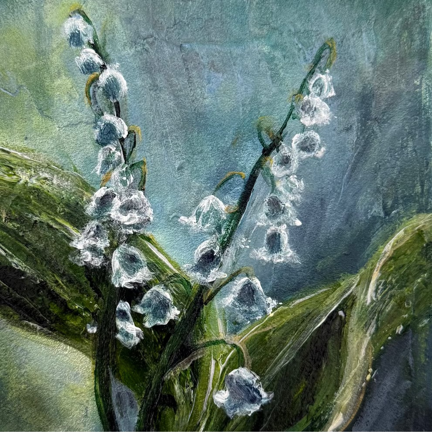 Artistic depiction of lily of the valley flowers with green leaves on a textured blue background floral acrylic palette knife painting by Allison Victoria deep greens and blues pops of white cool tones and texture on gallery wrapped canvas home decor zoomed in detail shot