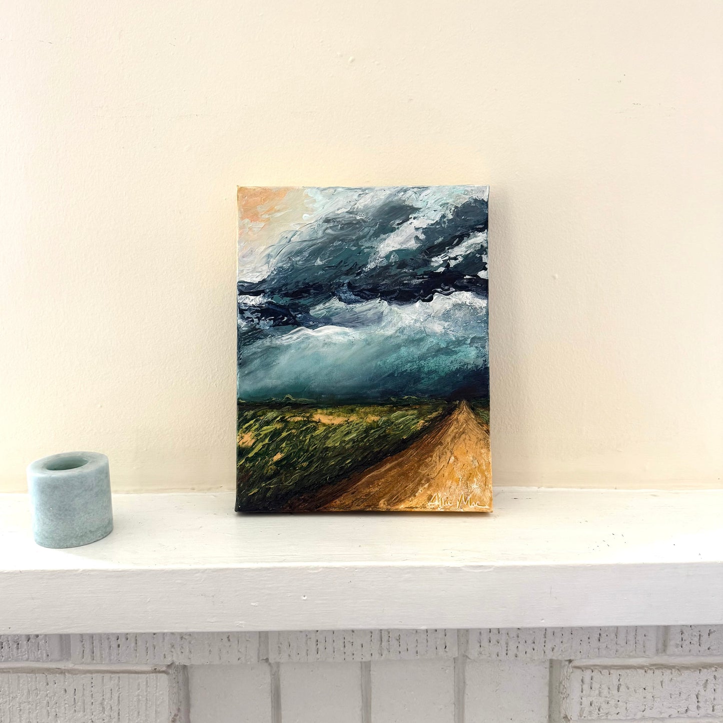 Canvas print of a landscape with a road and stormy sky on a white surface.