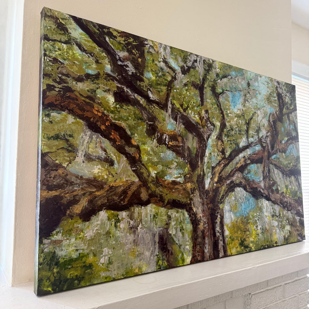 Large painting of a tree with green foliage and Spanish moss abstract and palette knife style on a mantle side angle