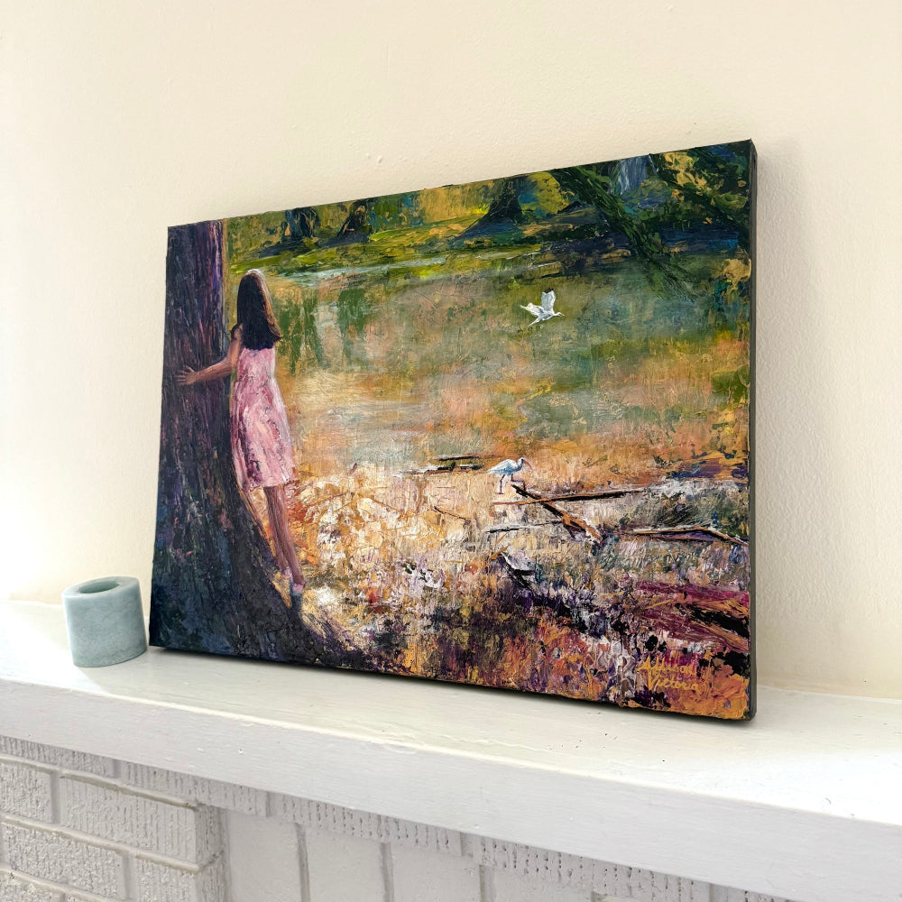 Side perspective of an impressionistic palette knife painting of a child birdwatching by a shoreline, highlighting texture and finished canvas edges.