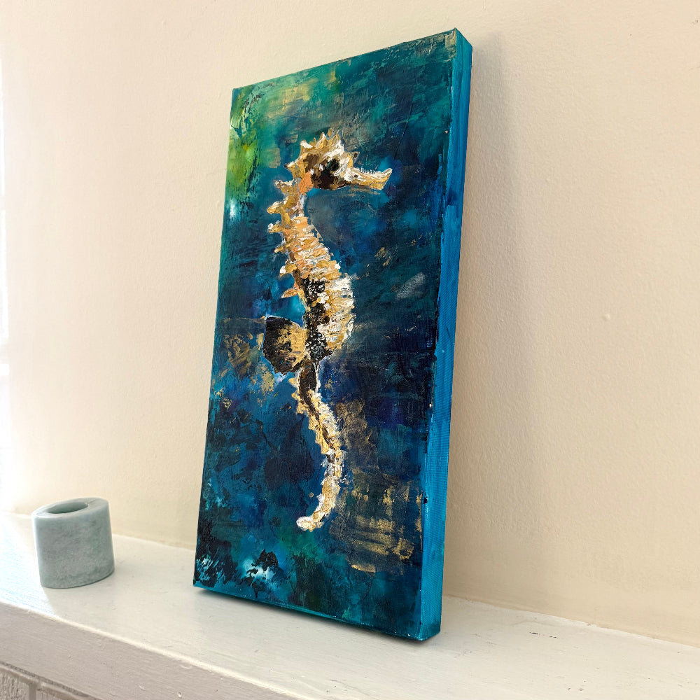 Canvas painting of a seahorse on a blue and green abstract background