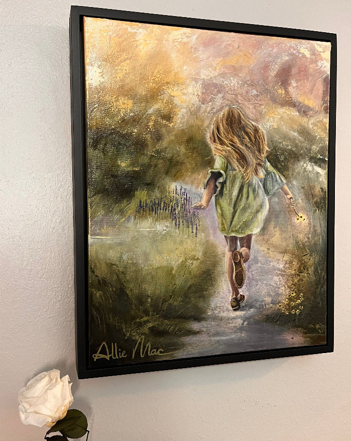 First Flowers original mixed media and oil painting by Allison Victoria featuring a young girl running down a spring path holding wildflowers in a dreamy impressionistic landscape hung on a wall next to a white rose