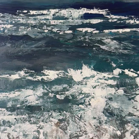 close up of large acrylic palette knife ocean painting of deep blues and greys and whites and browns that zooms out to show the whole painting resting on top of a light white neutral background