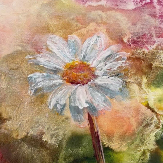 Video up close to daisy flower of small painting with abstract pinks gold and green background zooms out to show the painting on lgiht white neutral background