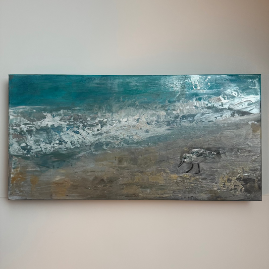 Abstract painting of shoreline ocean teal gray silver and gold with earthy tones on a plain wall with sandpiper beach bird acrylic palette knife painting thick texture