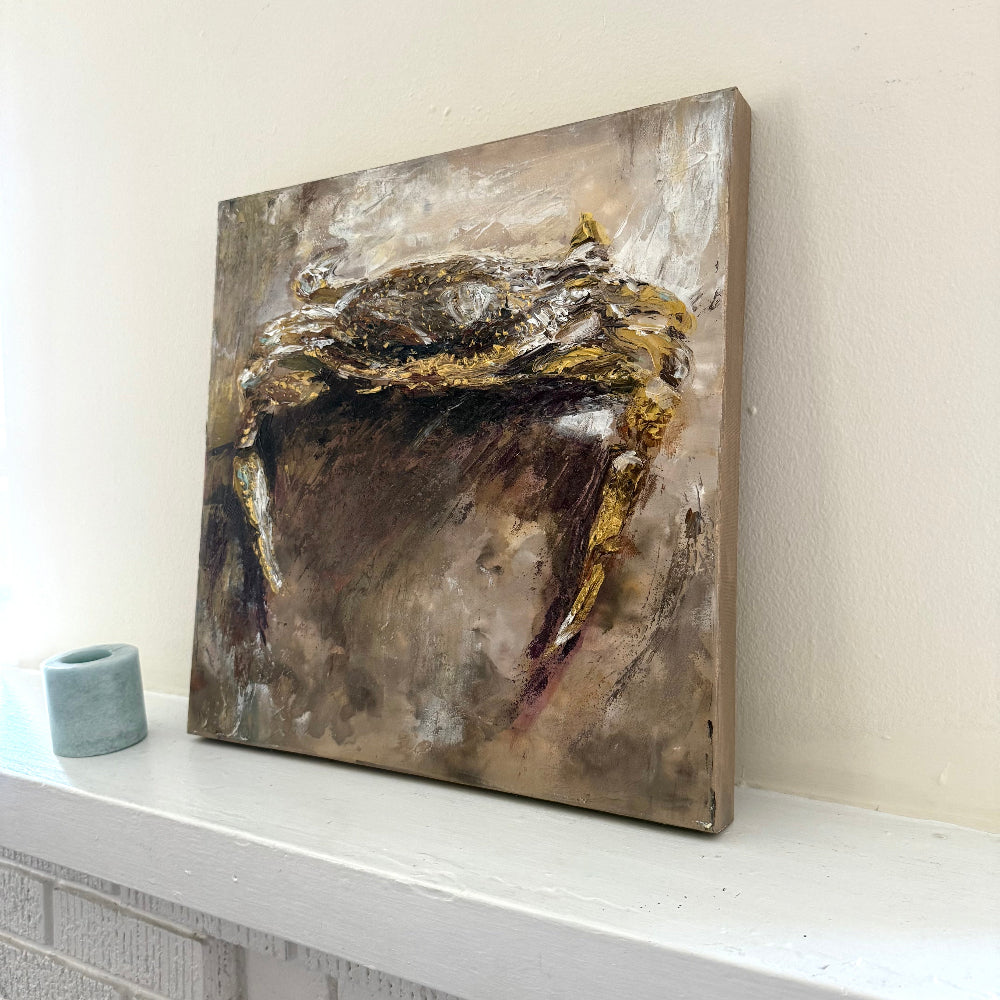 Abstract coastal crab acrylic palette knife painting with gold and brown tones on a white shelf against a light wall decor art