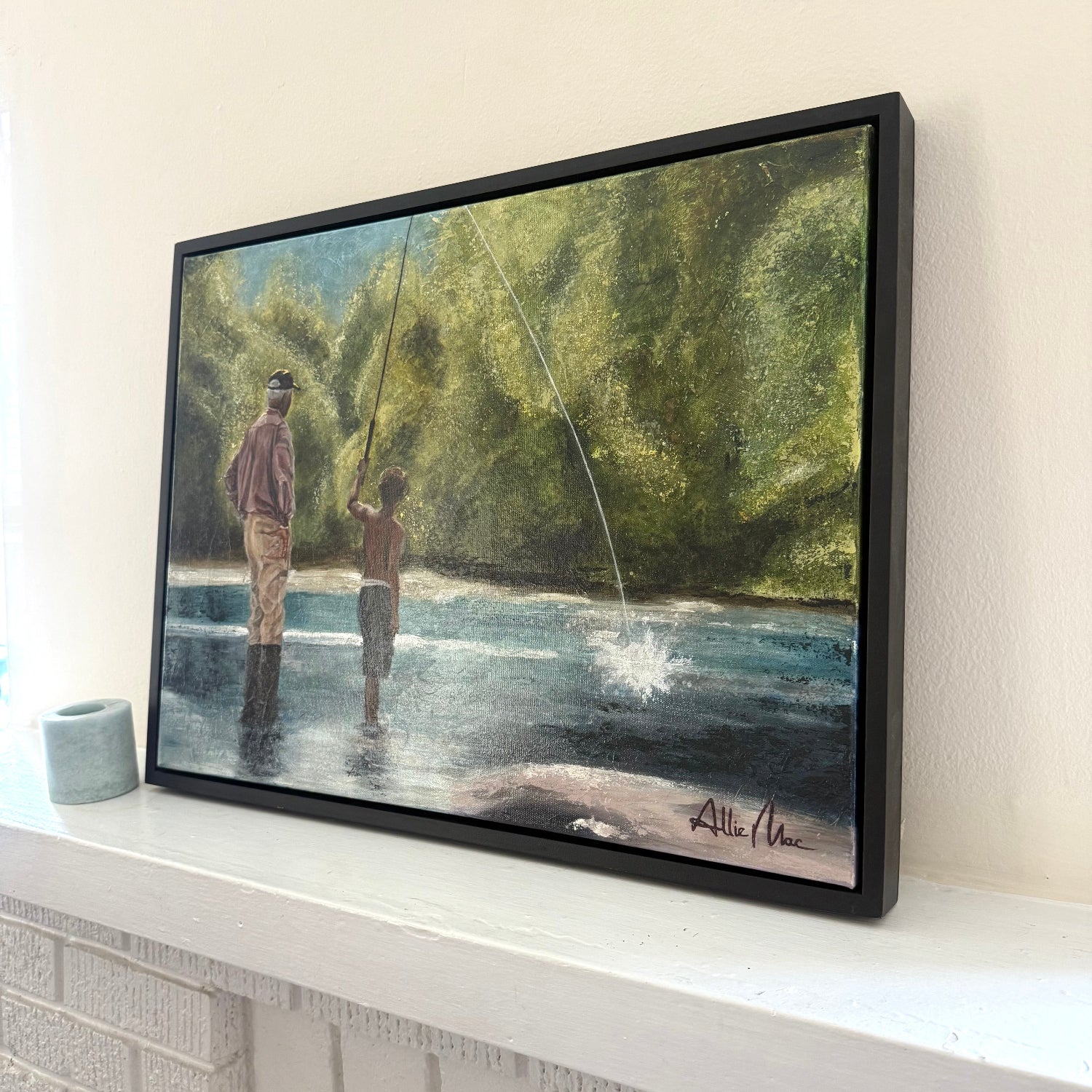 Teach a Man to Fish” by Allison Victoria — an impressionistic mixed media and oil painting of a grandfather teaching his grandson to fish in a peaceful river surrounded by glowing green trees and soft sunlight. The painting captures mentorship, discipleship, generational wisdom, faith, and the beauty of quiet childhood memories.